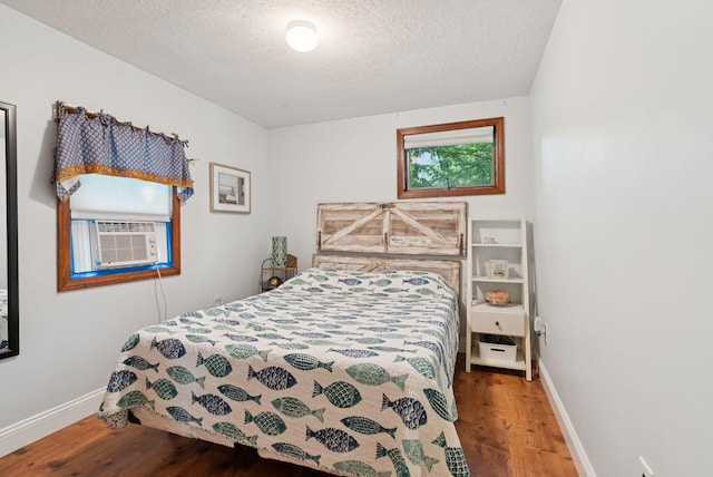 115 34th St, Acton, ME 04001 - bedroom with wood finished floors, cooling unit, and a textured ceiling