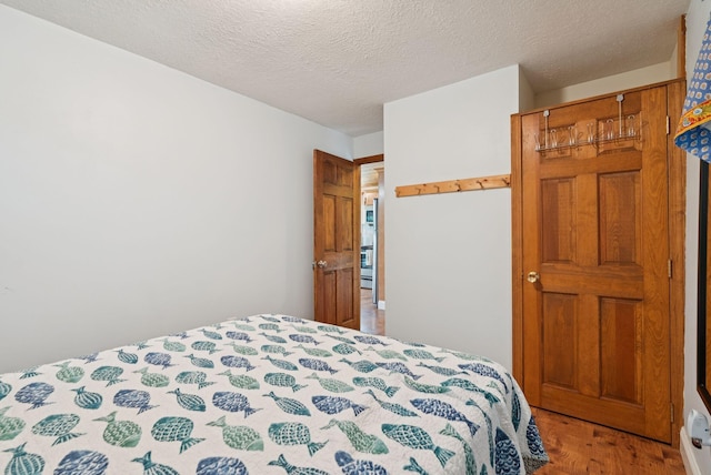 115 34th St, Acton, ME 04001 - bedroom with wood finished floors and a textured ceiling