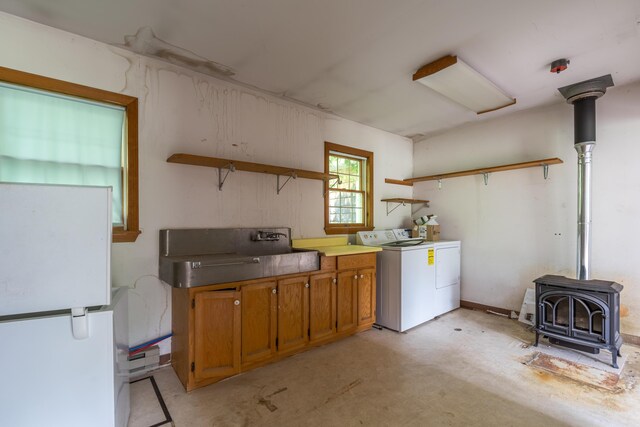 115 Swain Farm Rd, Rumford, ME 04276 - laundry area with a wood stove and washer / clothes dryer
