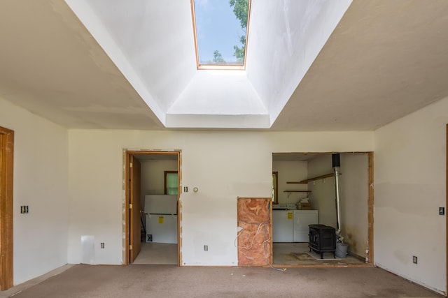 115 Swain Farm Rd, Rumford, ME 04276 - unfurnished bedroom featuring a wood stove, washing machine and dryer, carpet flooring, freestanding refrigerator, and a skylight