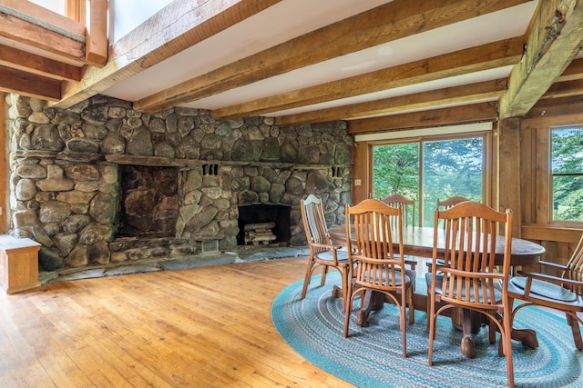 115 Swain Farm Rd, Rumford, ME 04276 - dining space featuring a fireplace, wood-type flooring, and beamed ceiling