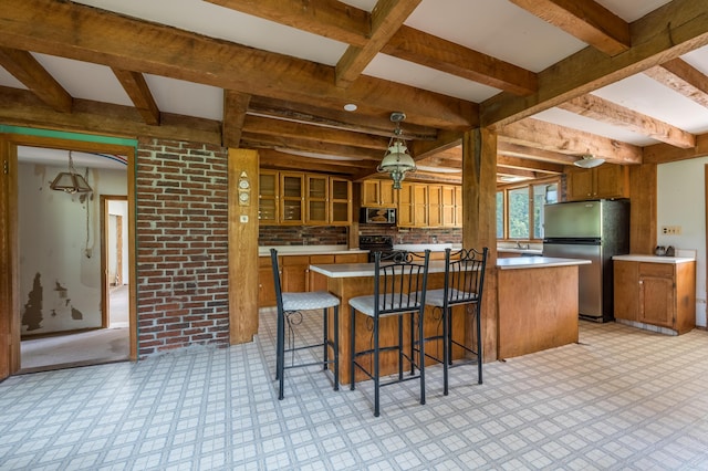 115 Swain Farm Rd, Rumford, ME 04276 - kitchen with freestanding refrigerator, built in microwave, brown cabinetry, black range with electric cooktop, and light countertops