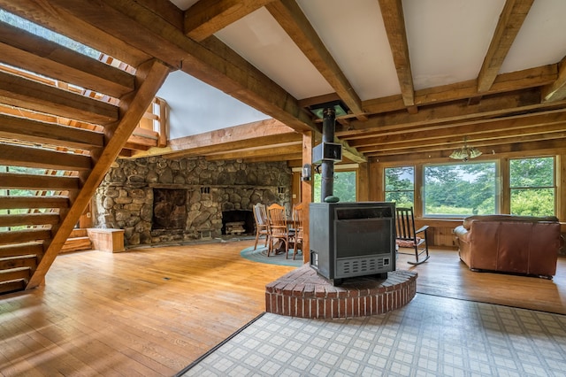 115 Swain Farm Rd, Rumford, ME 04276 - living area with a wood stove, beamed ceiling, and hardwood / wood-style flooring