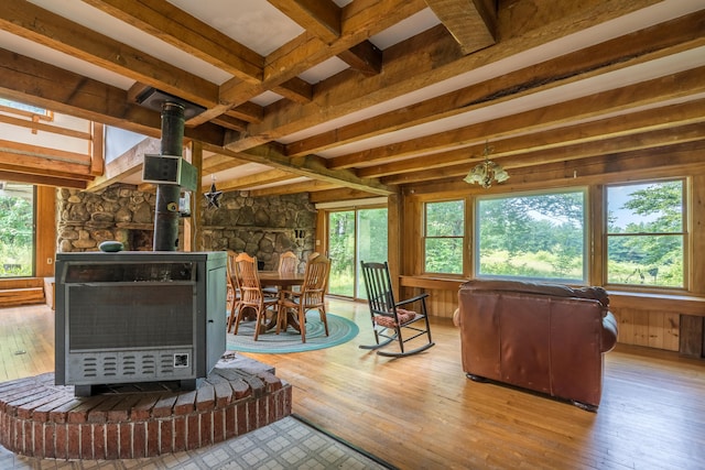 115 Swain Farm Rd, Rumford, ME 04276 - living area with a wood stove, hardwood / wood-style floors, beamed ceiling, and wood walls