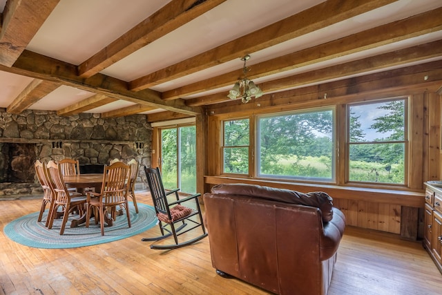 115 Swain Farm Rd, Rumford, ME 04276 - dining space with plenty of natural light, light wood-style floors, beam ceiling, and wood walls