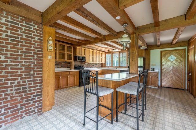 115 Swain Farm Rd, Rumford, ME 04276 - kitchen with black range with electric cooktop, beamed ceiling, stainless steel microwave, brown cabinetry, and light flooring