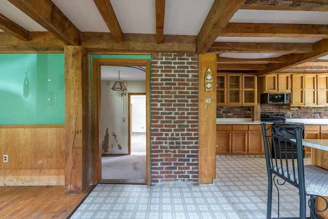 115 Swain Farm Rd, Rumford, ME 04276 - kitchen featuring beamed ceiling, brown cabinets, light countertops, stove, and stainless steel microwave