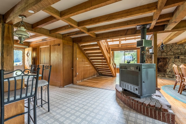 115 Swain Farm Rd, Rumford, ME 04276 - living area featuring a wood stove, plenty of natural light, beamed ceiling, wood walls, and heating unit