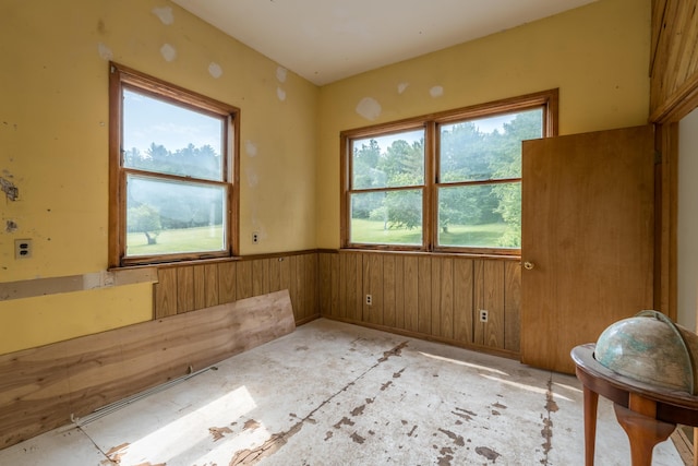 115 Swain Farm Rd, Rumford, ME 04276 - empty room featuring healthy amount of natural light, wainscoting, and wooden walls