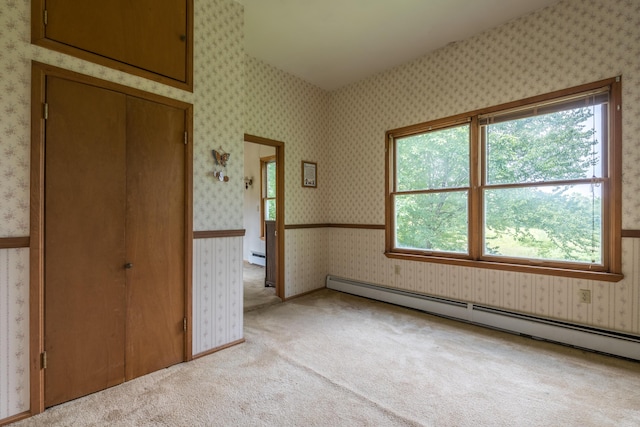 115 Swain Farm Rd, Rumford, ME 04276 - unfurnished bedroom featuring baseboard heating, multiple windows, light colored carpet, and wallpapered walls