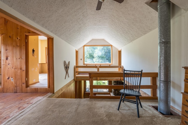 115 Swain Farm Rd, Rumford, ME 04276 - sitting room with a textured ceiling, wood walls, vaulted ceiling, ceiling fan, and a wainscoted wall