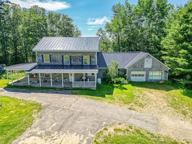 115 Swain Farm Rd, Rumford, ME 04276 - view of front facade with a standing seam roof, a porch, driveway, a front yard, and a metal roof