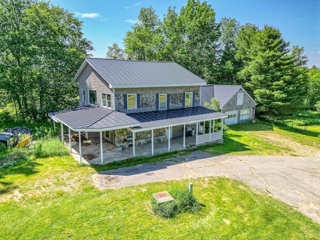 115 Swain Farm Rd, Rumford, ME 04276 - farmhouse featuring a standing seam roof, a front yard, and a metal roof
