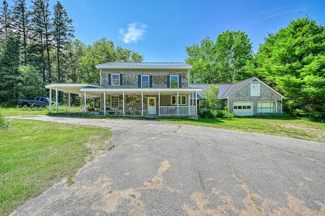 115 Swain Farm Rd, Rumford, ME 04276 - farmhouse-style home featuring a porch, asphalt driveway, a standing seam roof, a metal roof, and a front yard