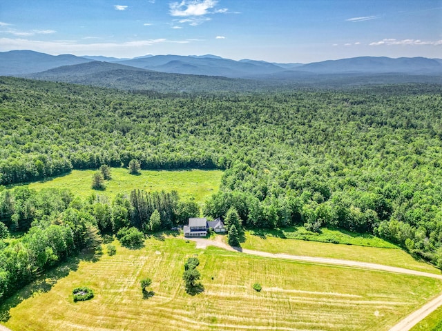 115 Swain Farm Rd, Rumford, ME 04276 - drone / aerial view of a heavily wooded area and a mountain backdrop