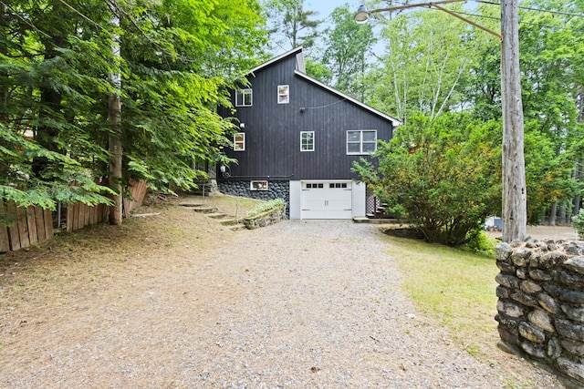 60 Butterworth Dr Unit 40, 46, Naples, ME 04055 - view of side of home with driveway, a garage, and stairway