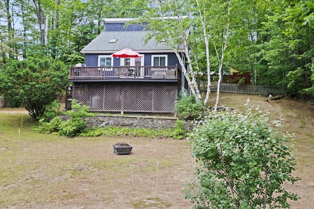 60 Butterworth Dr Unit 40, 46, Naples, ME 04055 - rear view of house featuring an outdoor fire pit, a wooden deck, and a shingled roof