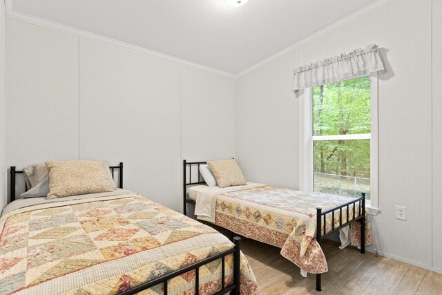 60 Butterworth Dr Unit 40, 46, Naples, ME 04055 - bedroom featuring light wood-type flooring and crown molding