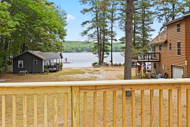 60 Butterworth Dr Unit 40, 46, Naples, ME 04055 - view of yard with a deck with water view, driveway, and an attached garage