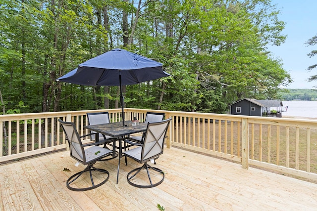 60 Butterworth Dr Unit 40, 46, Naples, ME 04055 - deck featuring outdoor dining area, a water view, and view of wooded area