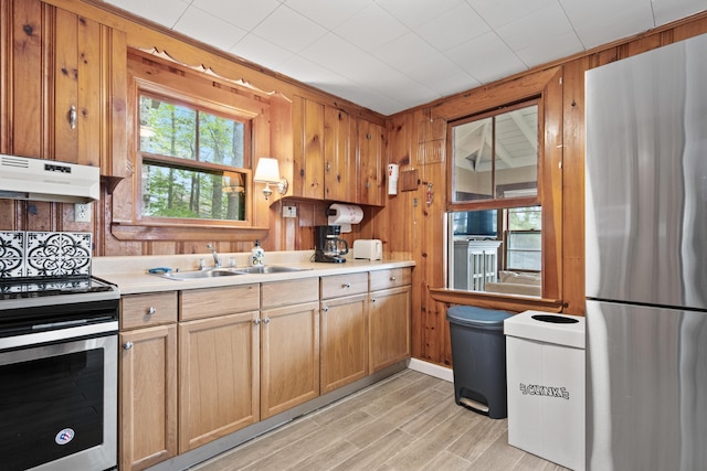 60 Butterworth Dr Unit 40, 46, Naples, ME 04055 - kitchen featuring stainless steel appliances, under cabinet range hood, light countertops, light wood finished floors, and wood walls