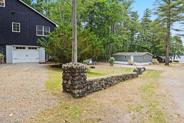 60 Butterworth Dr Unit 40, 46, Naples, ME 04055 - view of home's exterior with gravel driveway and an attached garage