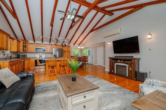 15 Vine St Unit B, South Berwick, ME 03908 - living room with an AC wall unit, ceiling fan, light wood-style flooring, and a chandelier