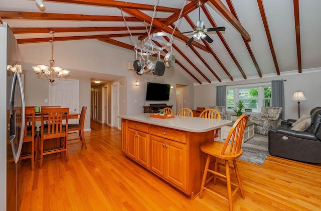 15 Vine St Unit B, South Berwick, ME 03908 - kitchen featuring open floor plan, a breakfast bar, a chandelier, stainless steel fridge with ice dispenser, and light countertops