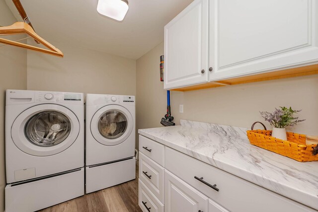 15 Vine St Unit B, South Berwick, ME 03908 - washroom featuring cabinet space, separate washer and dryer, and light wood-style flooring