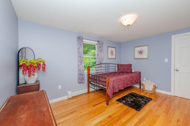 15 Vine St Unit B, South Berwick, ME 03908 - bedroom with wood finished floors and a baseboard heating unit