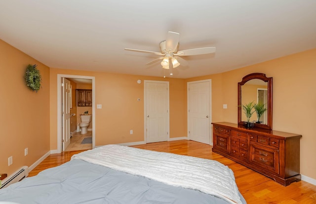 15 Vine St Unit B, South Berwick, ME 03908 - bedroom with a baseboard heating unit, light wood-style floors, ensuite bath, and ceiling fan