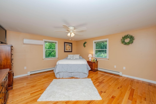 15 Vine St Unit B, South Berwick, ME 03908 - bedroom with baseboard heating, light wood-type flooring, and ceiling fan