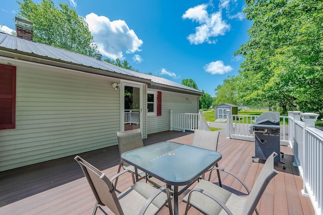 15 Vine St Unit B, South Berwick, ME 03908 - deck with outdoor dining area, a storage shed, and a grill