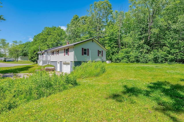 15 Vine St Unit B, South Berwick, ME 03908 - view of property exterior featuring a garage, a chimney, and driveway