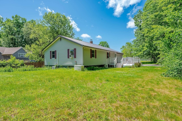 15 Vine St Unit B, South Berwick, ME 03908 - rear view of house with a chimney, a metal roof, a yard, a wooden deck, and cooling unit