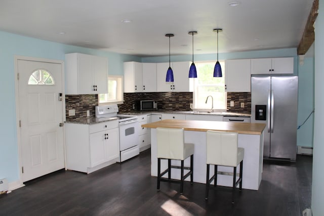 49 Horace Files Rd, Naples, ME 04055 - kitchen with stainless steel appliances, baseboard heating, tasteful backsplash, and white cabinets