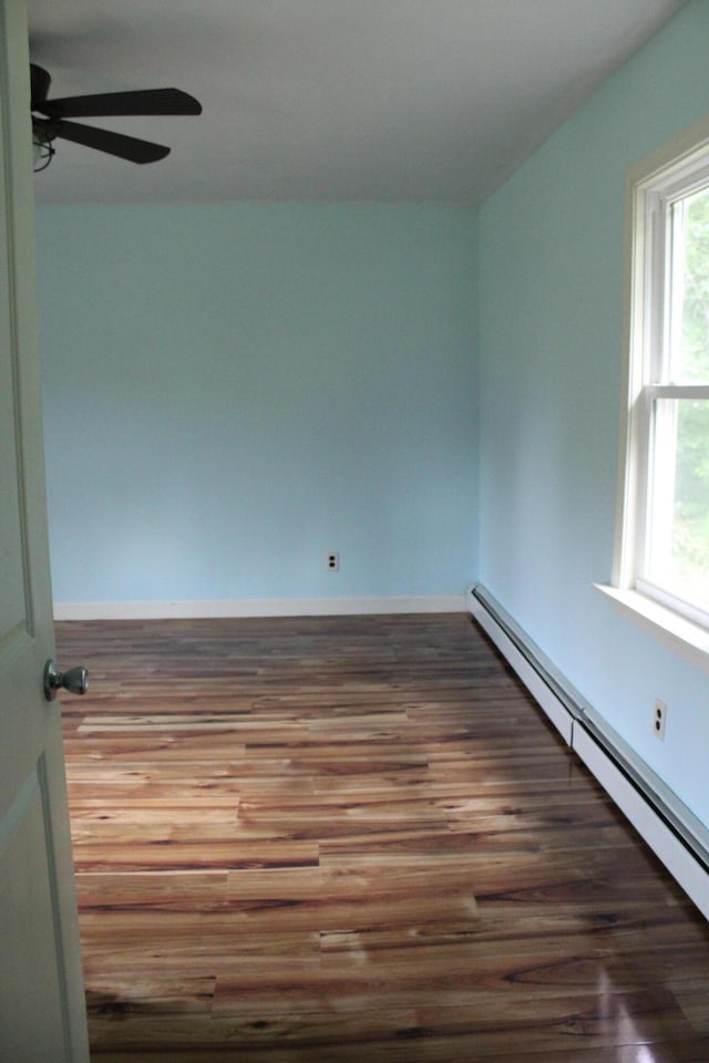 49 Horace Files Rd, Naples, ME 04055 - unfurnished room featuring a baseboard radiator, wood finished floors, and ceiling fan