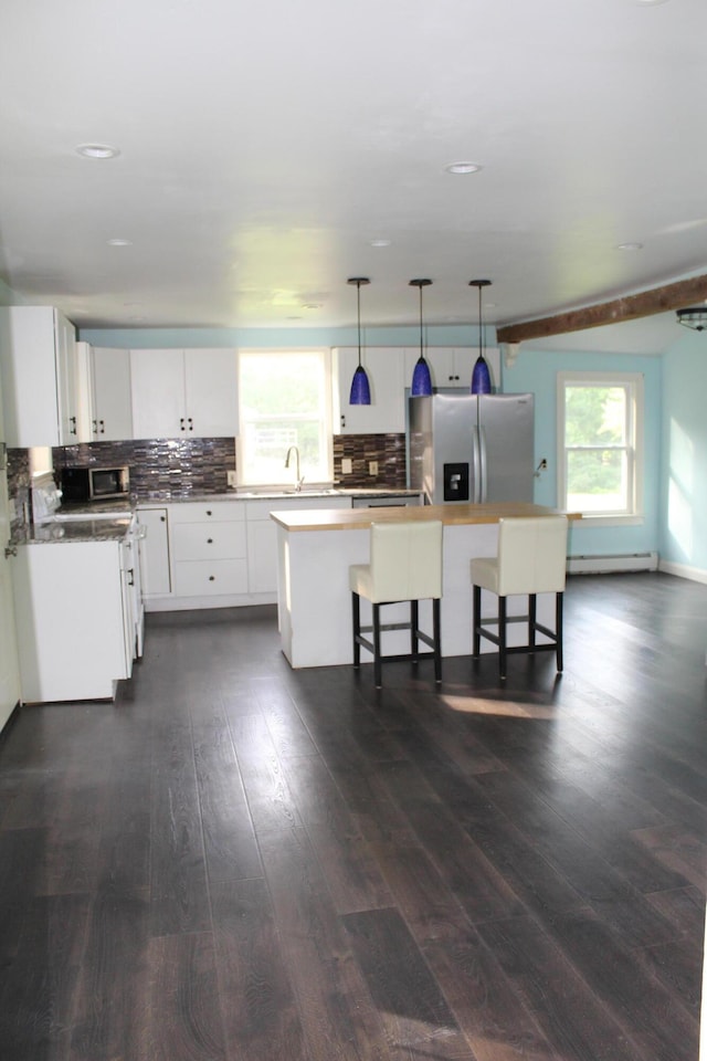 49 Horace Files Rd, Naples, ME 04055 - kitchen with appliances with stainless steel finishes, a center island, dark wood finished floors, backsplash, and white cabinets