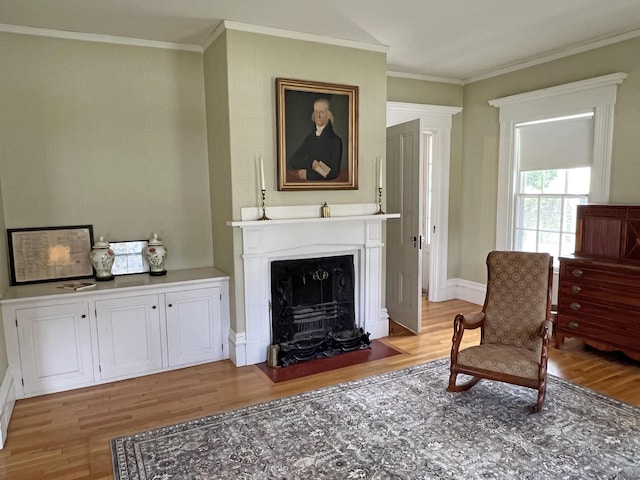 95 Main St, Castine, ME 04421 - sitting room featuring light wood-type flooring, ornamental molding, and a fireplace with flush hearth