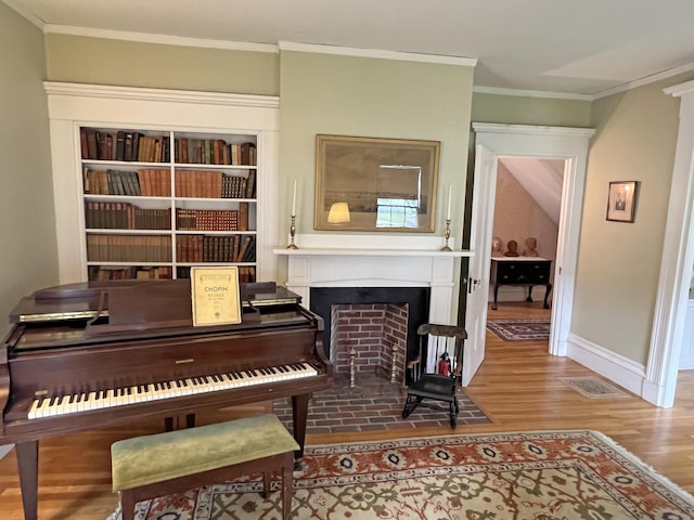 95 Main St, Castine, ME 04421 - living area featuring wood finished floors, ornamental molding, a fireplace with flush hearth, and built in features