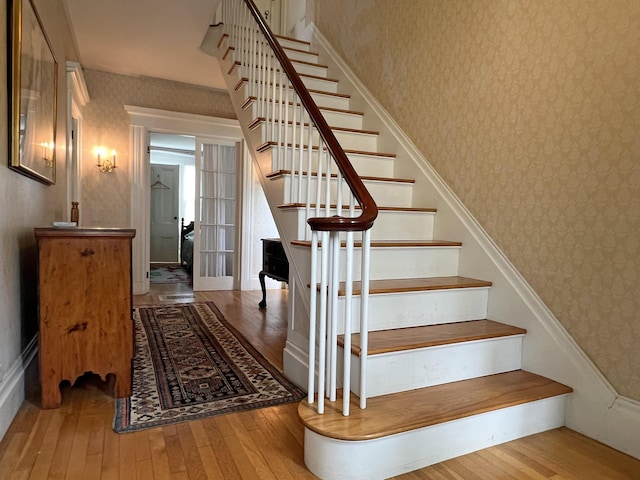 95 Main St, Castine, ME 04421 - stairs featuring wallpapered walls and hardwood / wood-style flooring