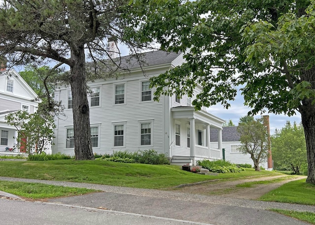 95 Main St, Castine, ME 04421 - view of front of home with a chimney, a front yard, and a shingled roof