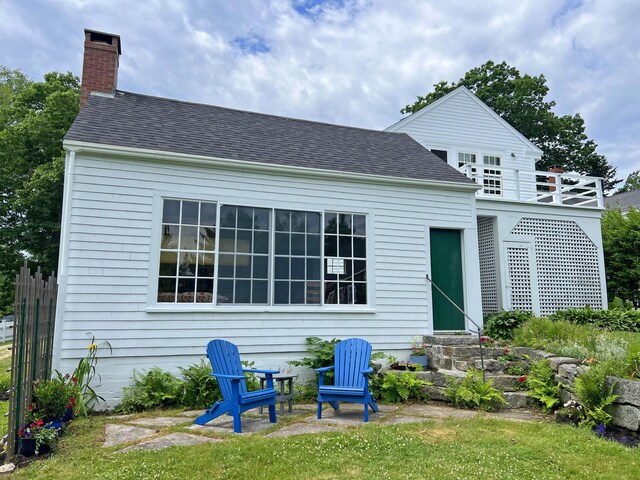 95 Main St, Castine, ME 04421 - rear view of house featuring a chimney, a shingled roof, and entry steps
