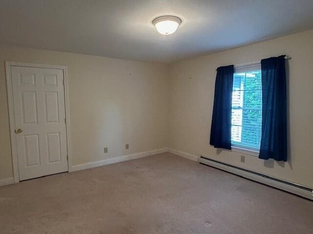 1 S Ridge Dr, Winslow, ME 04901 - carpeted empty room featuring a baseboard heating unit and baseboards