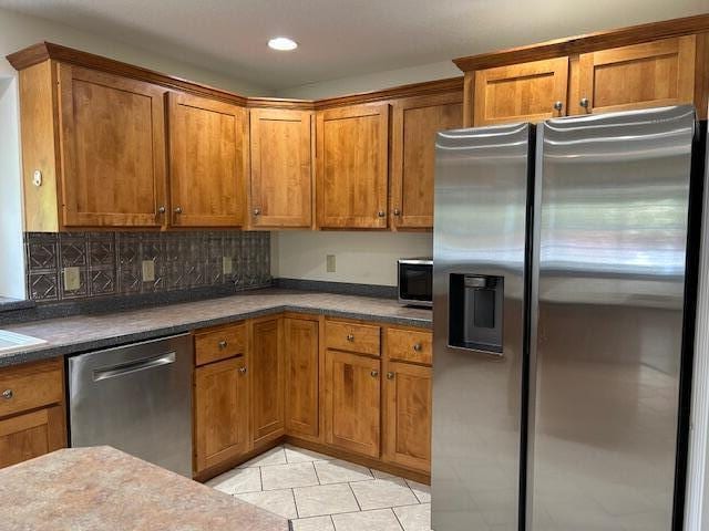 1 S Ridge Dr, Winslow, ME 04901 - kitchen featuring appliances with stainless steel finishes, brown cabinetry, light tile patterned floors, and recessed lighting