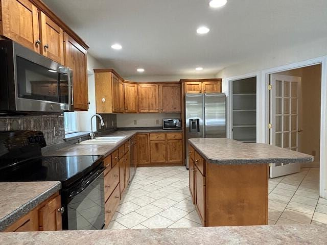 1 S Ridge Dr, Winslow, ME 04901 - kitchen featuring stainless steel appliances, brown cabinets, a kitchen island, recessed lighting, and dark countertops