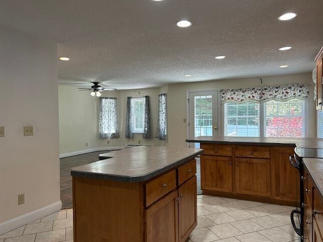 1 S Ridge Dr, Winslow, ME 04901 - kitchen featuring black electric range, recessed lighting, dark countertops, a ceiling fan, and brown cabinetry
