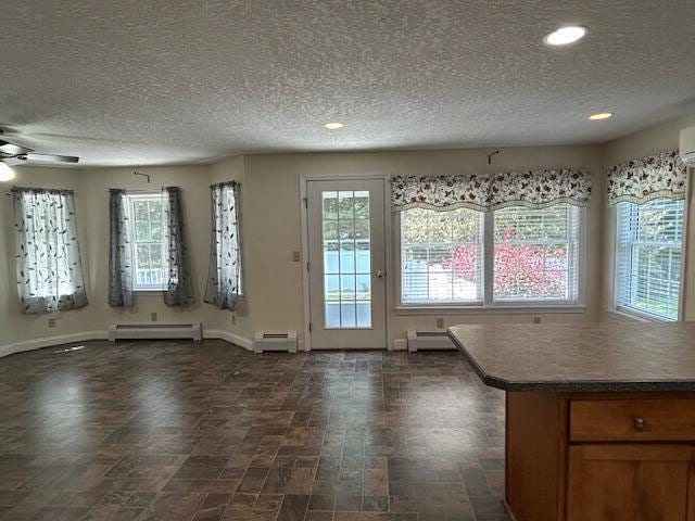 1 S Ridge Dr, Winslow, ME 04901 - unfurnished dining area with a baseboard radiator, a textured ceiling, recessed lighting, and a ceiling fan