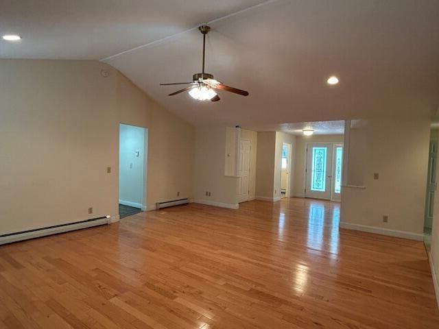 1 S Ridge Dr, Winslow, ME 04901 - unfurnished living room featuring a ceiling fan, light wood finished floors, vaulted ceiling, a baseboard heating unit, and a baseboard radiator