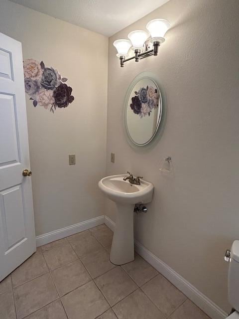 1 S Ridge Dr, Winslow, ME 04901 - half bathroom with tile patterned floors and toilet